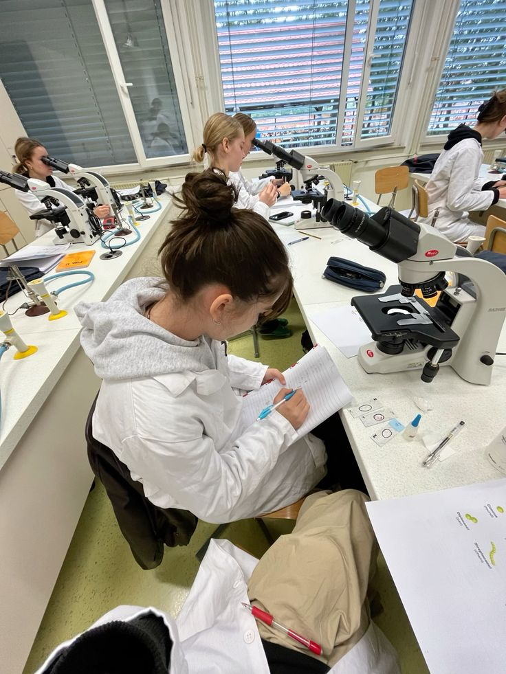 Students working with microscopes in a laboratory